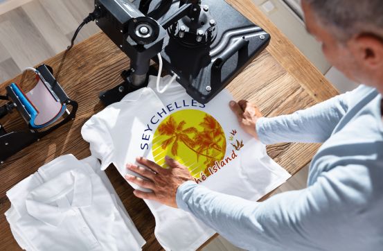 Heat transfers being applied via a heat press